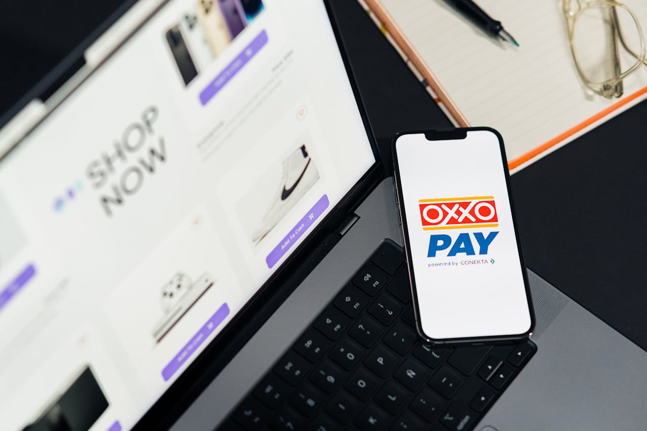 gallery-03 A mobile phone with OXXO Pay on a laptop used for online shopping.
